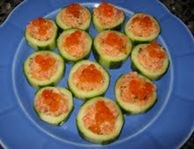 Salmon salad filled cuc cups ganished with salmon roe